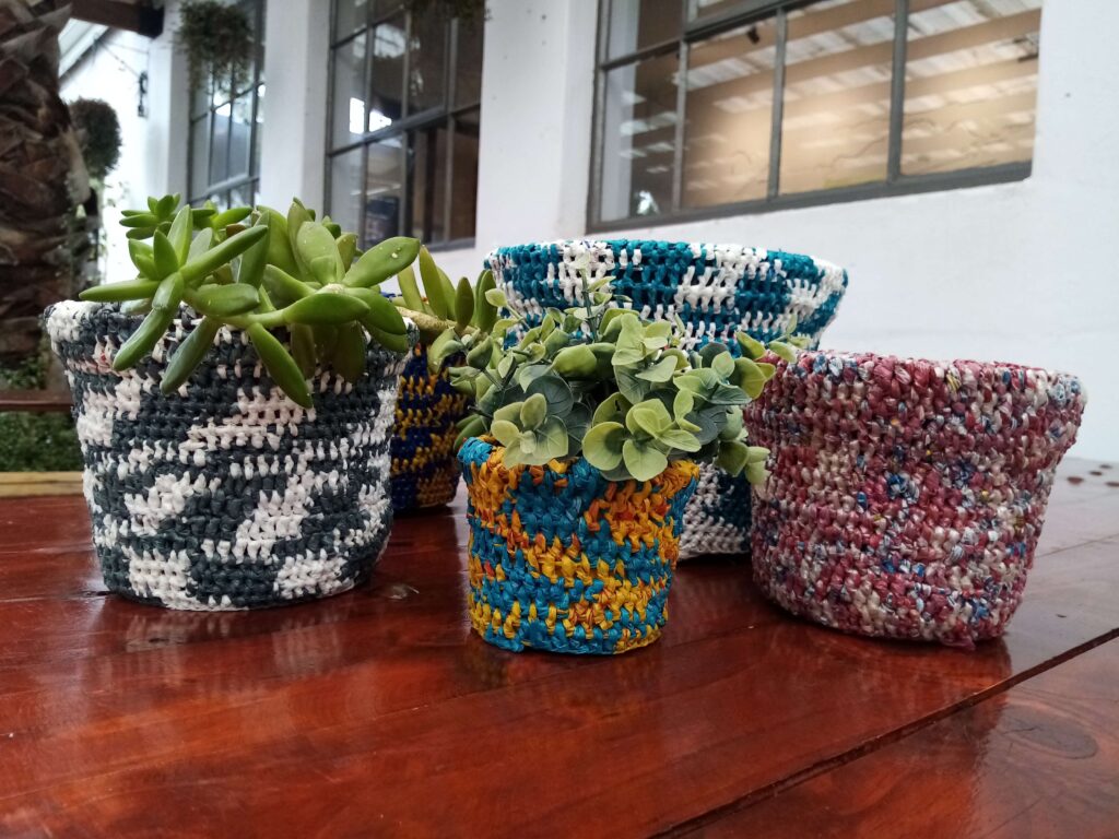 Image of pot plant covers made from re-used plastic carrier bags.